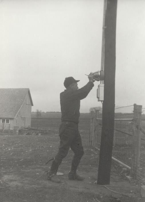 man installing meter on pole