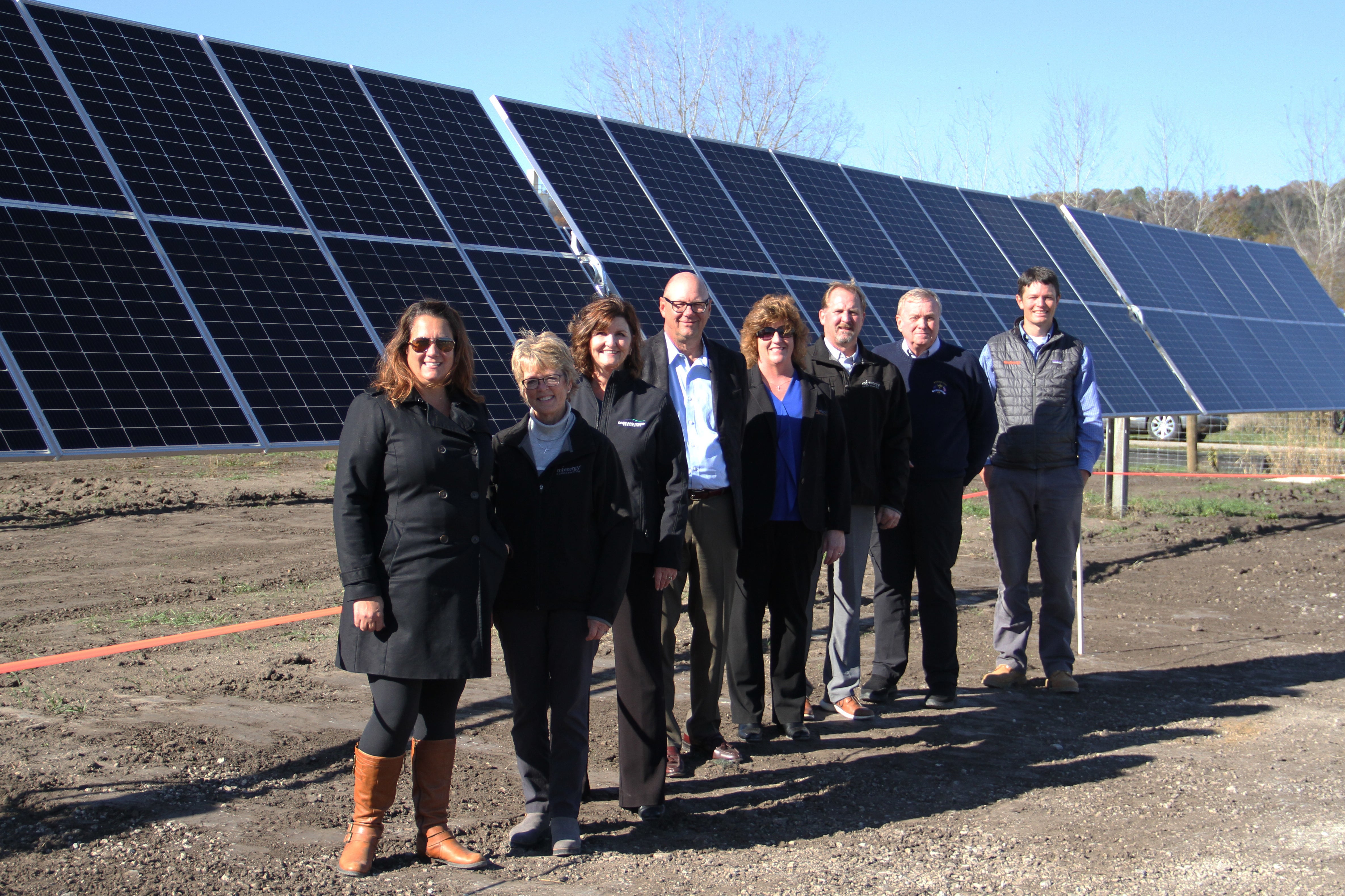 people in front of solar array