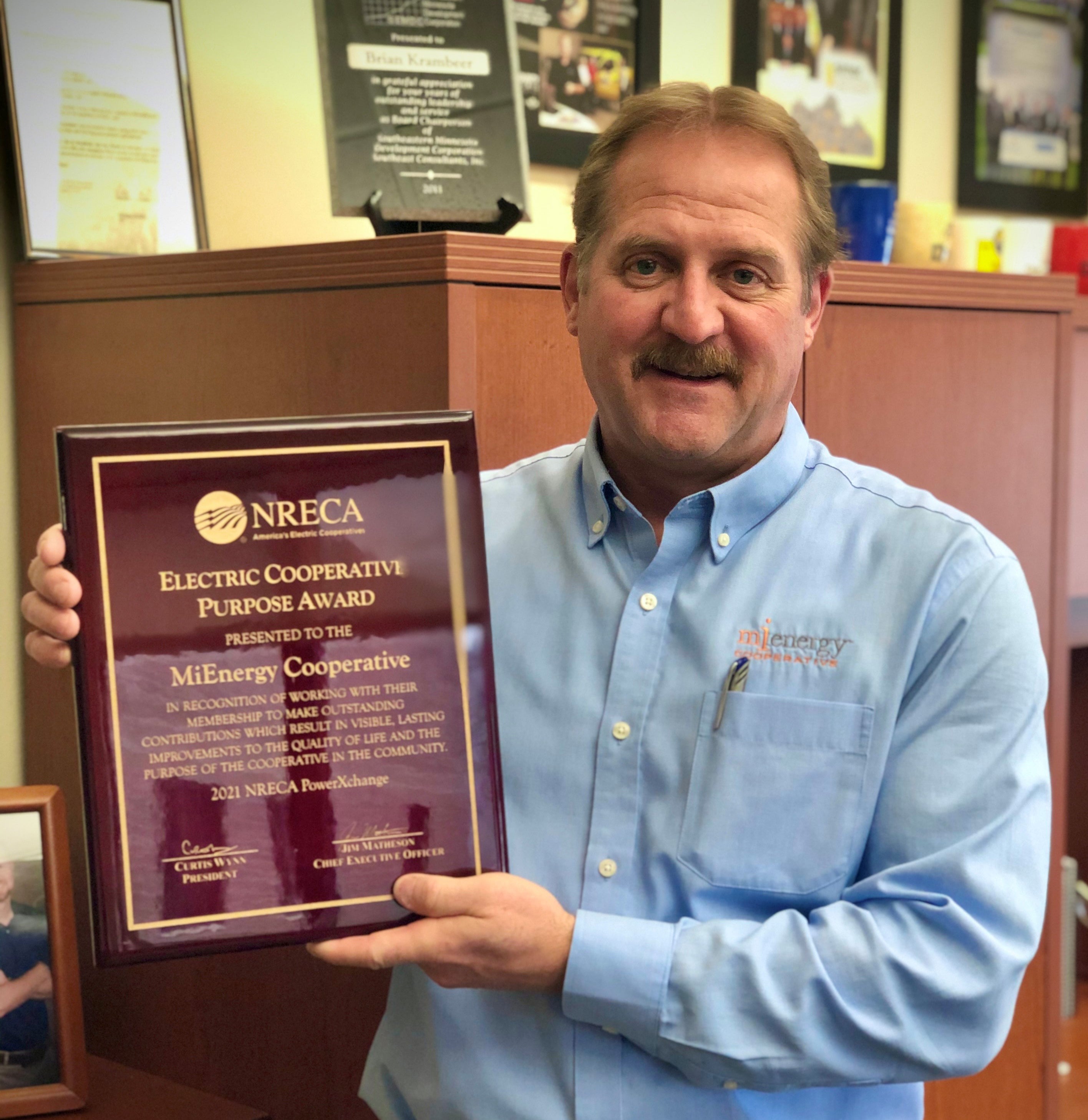 Brian Krambeer holding award